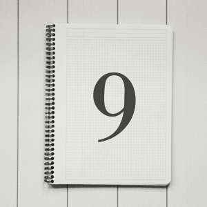 Black and white image of a notebook with the number 9