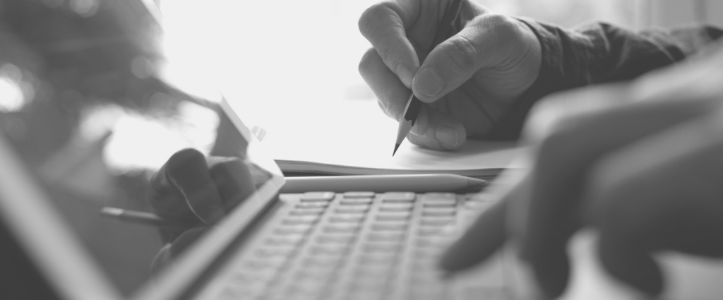 Training New Header Close-up of a hand writing on a piece of paper